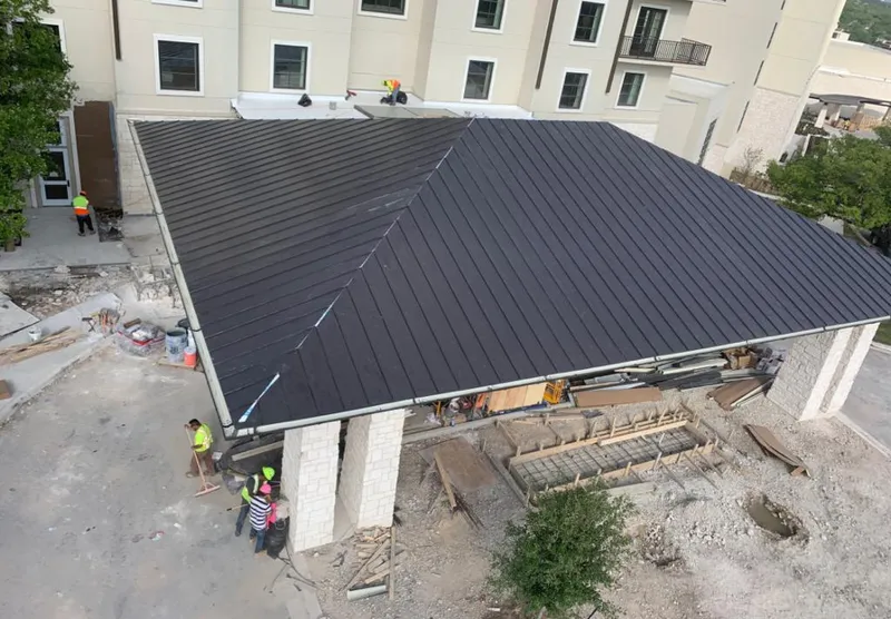 Metal roofing installation team working on a commercial building in Mount Vernon